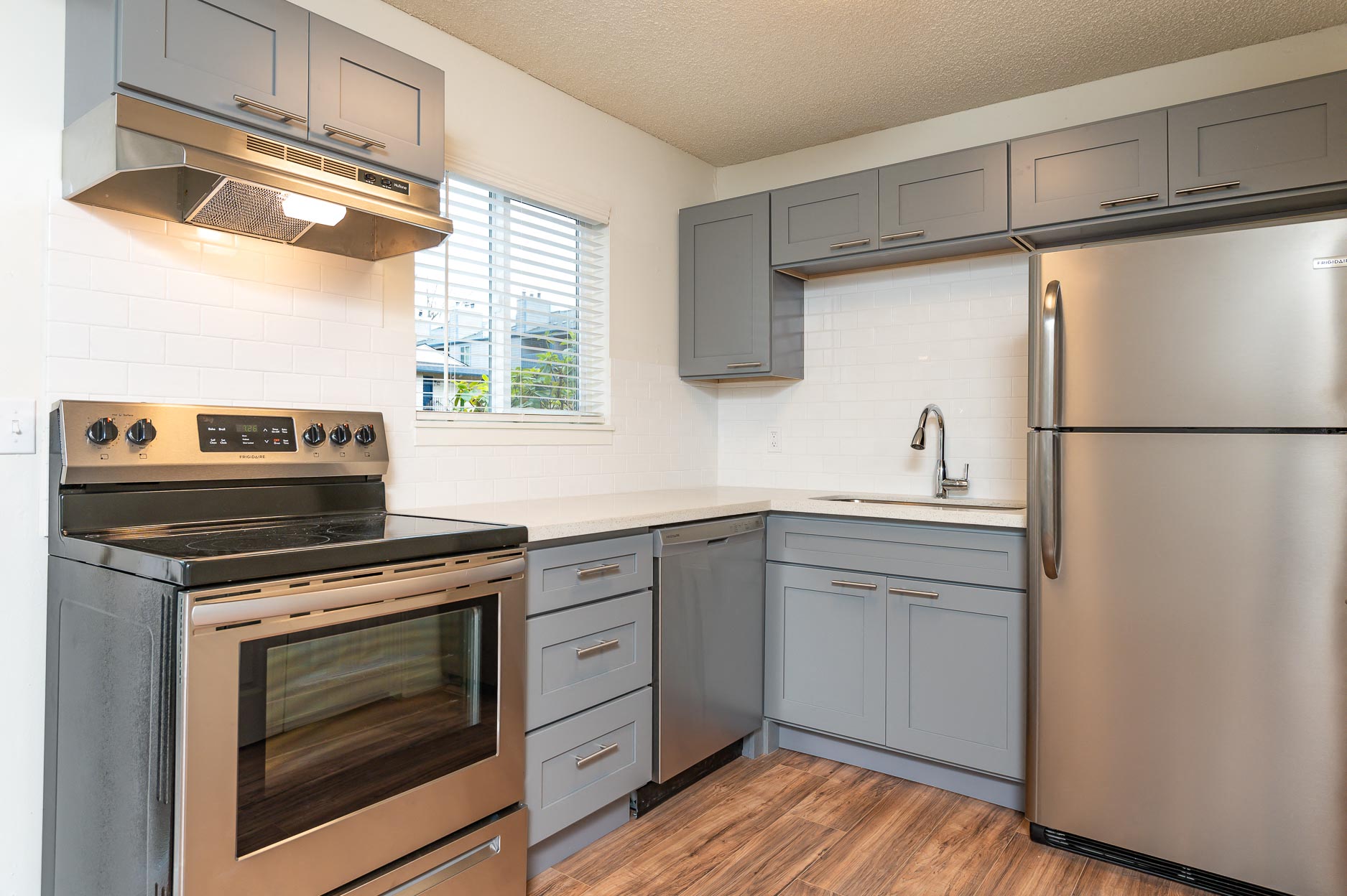 a kitchen with stainless steel appliances and white cabinets
